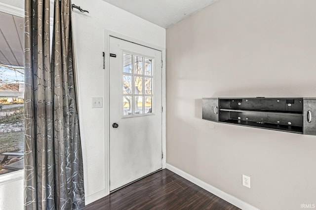 entryway featuring dark wood-style flooring and baseboards