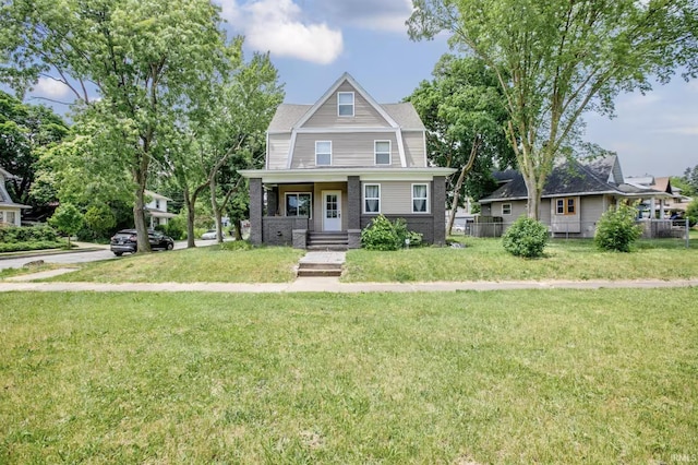 view of front of house with a front yard and brick siding