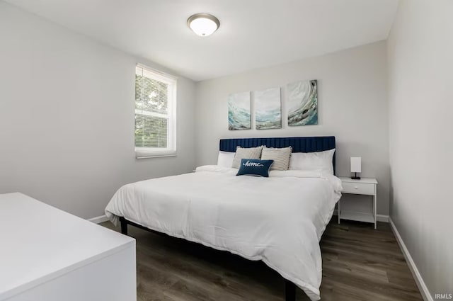 bedroom featuring dark wood-style floors and baseboards