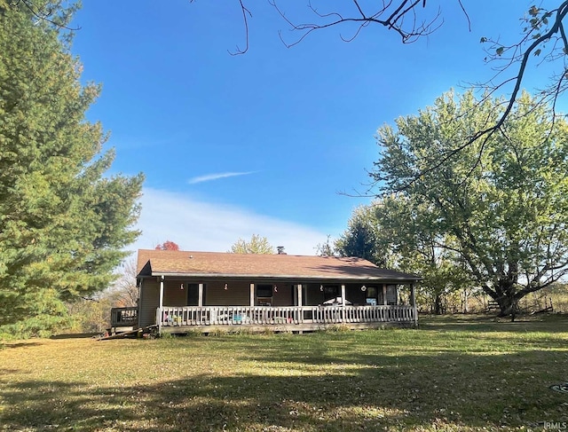 view of front of house with a front yard and a wooden deck