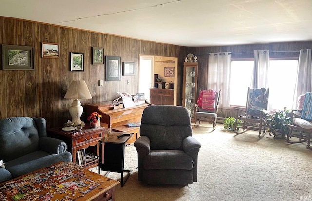 carpeted living room with wood walls