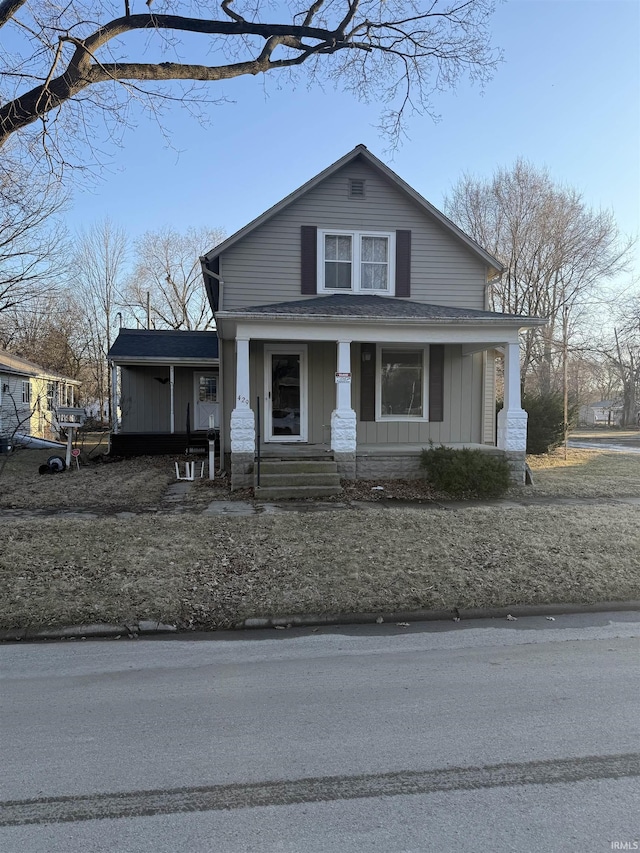 bungalow-style home with covered porch and board and batten siding