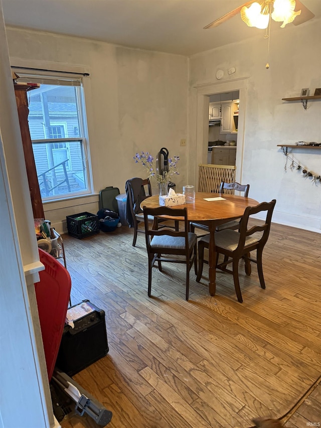 dining area with hardwood / wood-style flooring and a ceiling fan