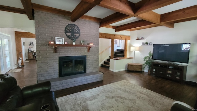 living area with arched walkways, a fireplace, baseboards, stairs, and dark wood finished floors