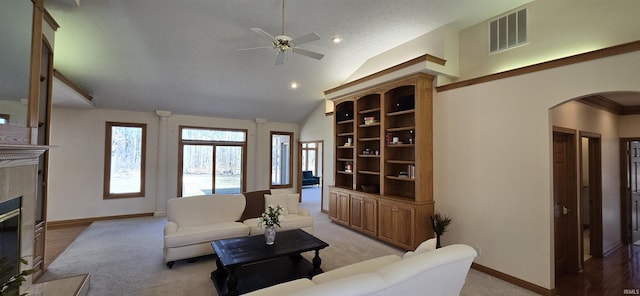 living room featuring arched walkways, a fireplace, visible vents, high vaulted ceiling, and baseboards