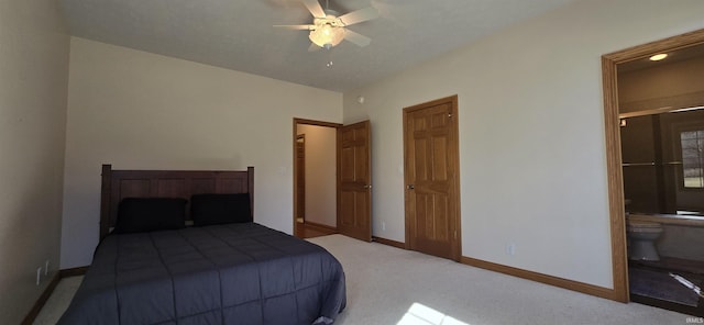 bedroom with light carpet, ensuite bath, baseboards, and ceiling fan