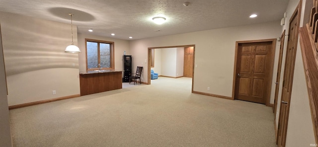 unfurnished room featuring light carpet, baseboards, a textured ceiling, and recessed lighting