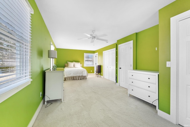 bedroom featuring ceiling fan, baseboards, and light colored carpet