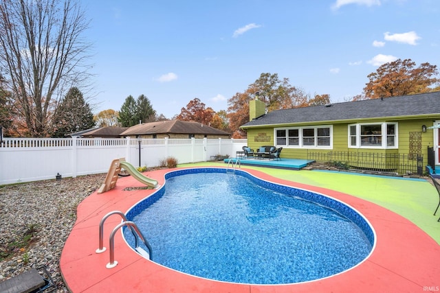 view of swimming pool with a patio area and a fenced backyard