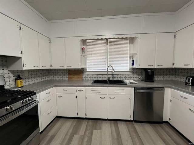 kitchen with white cabinets, stainless steel appliances, and a sink