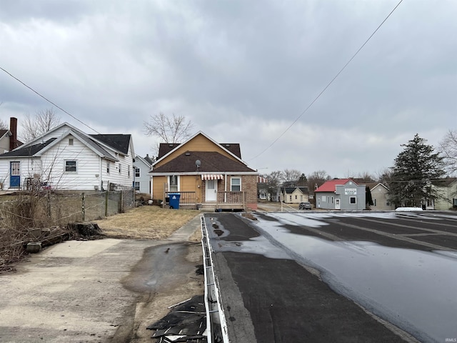 view of road featuring curbs and a residential view