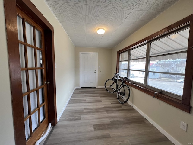 hallway with light wood finished floors and baseboards