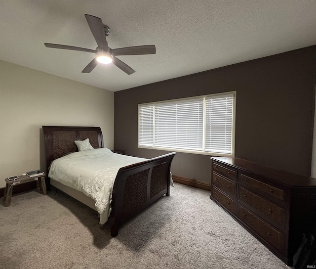 bedroom with light carpet, ceiling fan, and a textured ceiling