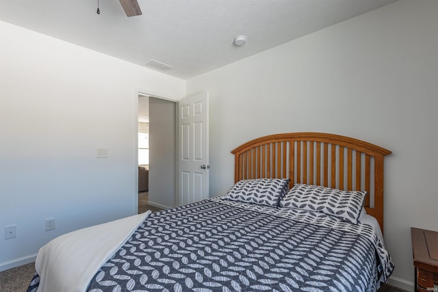 carpeted bedroom with ceiling fan, visible vents, and baseboards