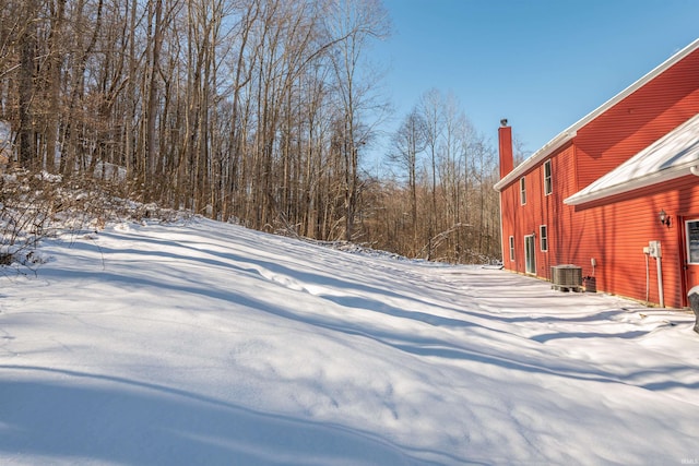 yard covered in snow with central AC