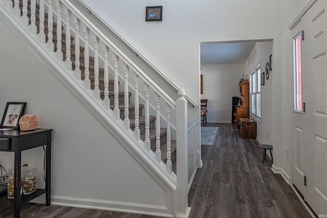 foyer with a healthy amount of sunlight, baseboards, and dark wood-style flooring