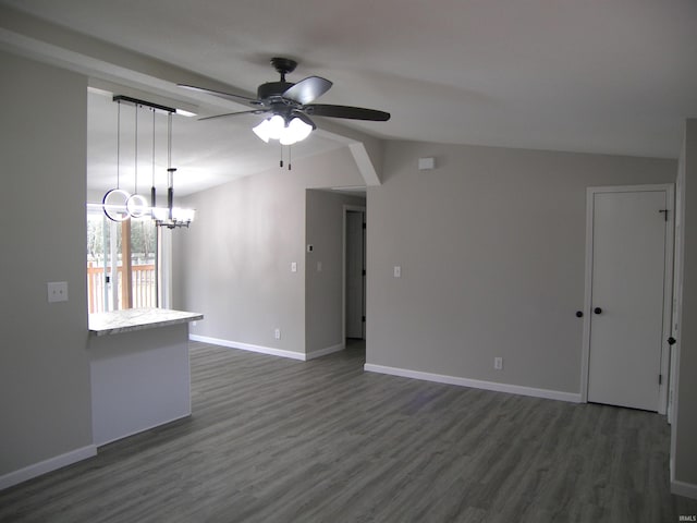 unfurnished living room with lofted ceiling, dark wood-style floors, ceiling fan, and baseboards