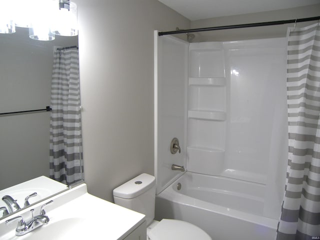 bathroom featuring toilet, shower / bath combination with curtain, and vanity