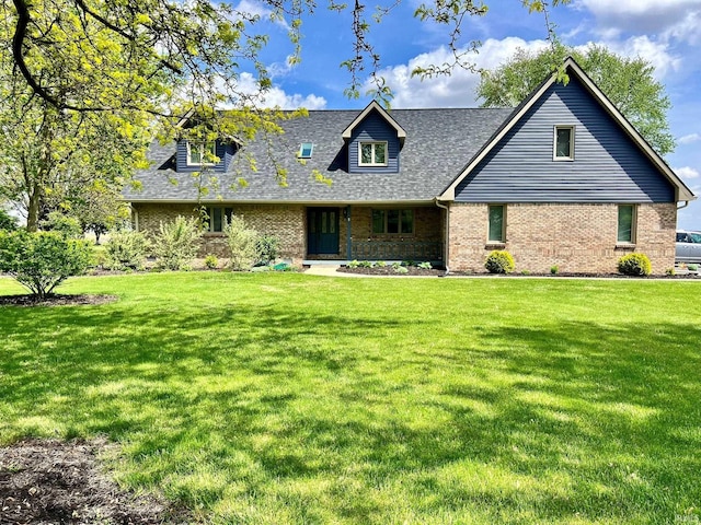 cape cod-style house with brick siding, roof with shingles, and a front yard