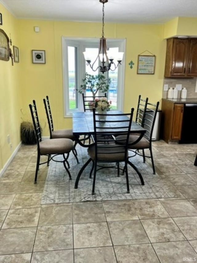 dining room with light tile patterned floors, baseboards, and a notable chandelier