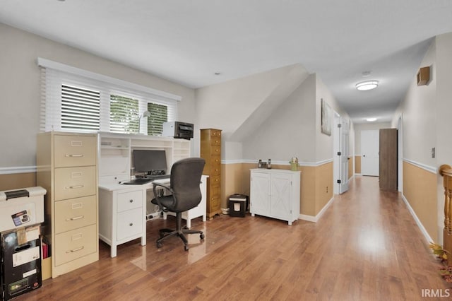 office space featuring baseboards and wood finished floors