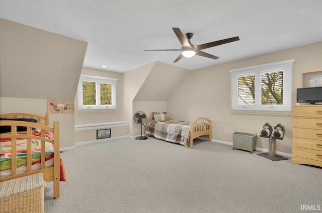 bedroom featuring lofted ceiling, ceiling fan, light carpet, and baseboards