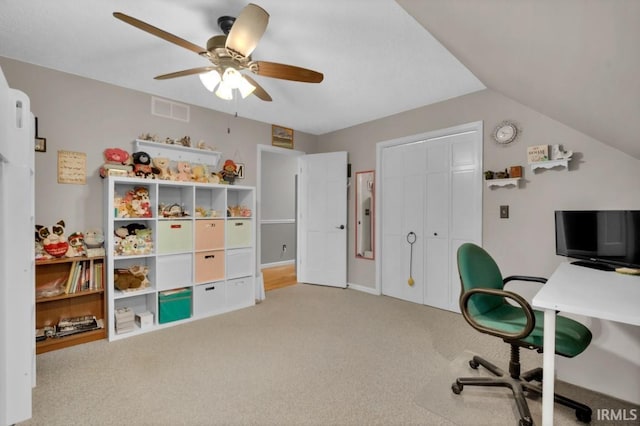 office area featuring lofted ceiling, visible vents, ceiling fan, and light carpet