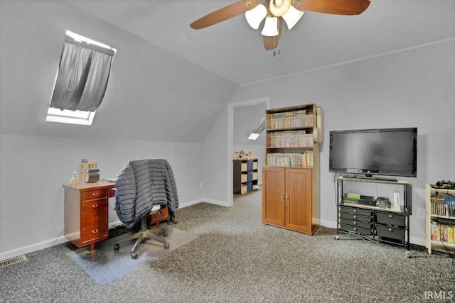 carpeted home office with visible vents, vaulted ceiling, baseboards, and ceiling fan