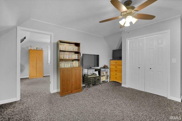 office featuring a ceiling fan, baseboards, vaulted ceiling, and carpet flooring