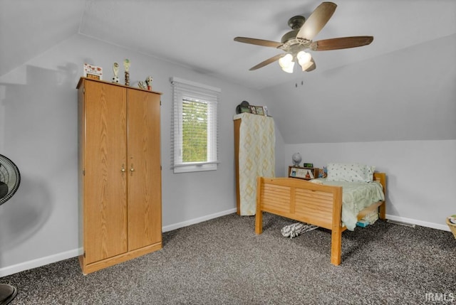 bedroom with lofted ceiling, dark colored carpet, a ceiling fan, and baseboards