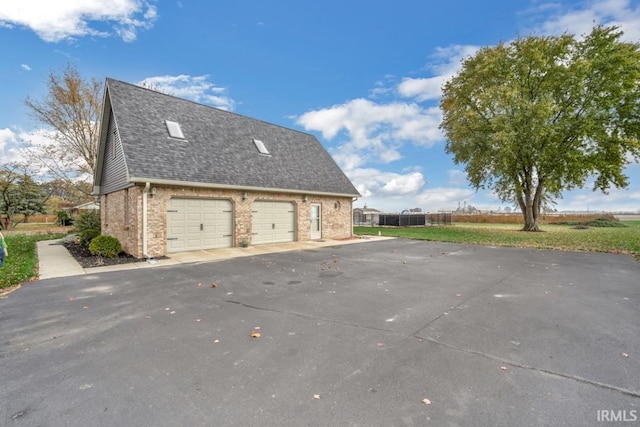 view of side of home featuring a garage, roof with shingles, and brick siding