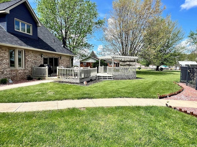 view of yard featuring a deck and a pergola