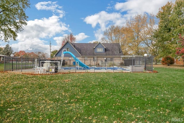 rear view of house featuring a lawn, a playground, fence, and a fenced in pool