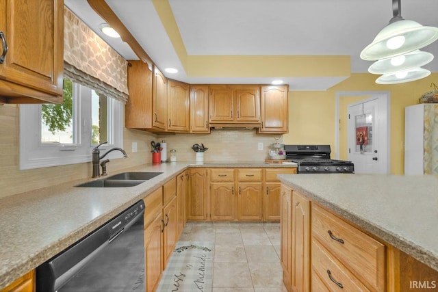 kitchen with dishwasher, stove, light countertops, and a sink