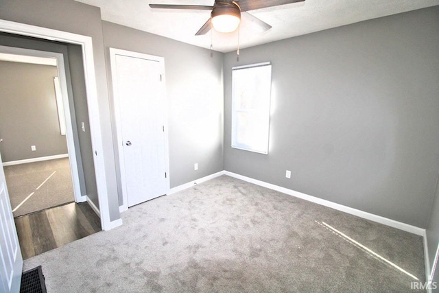 unfurnished bedroom with a closet, baseboards, and carpet flooring