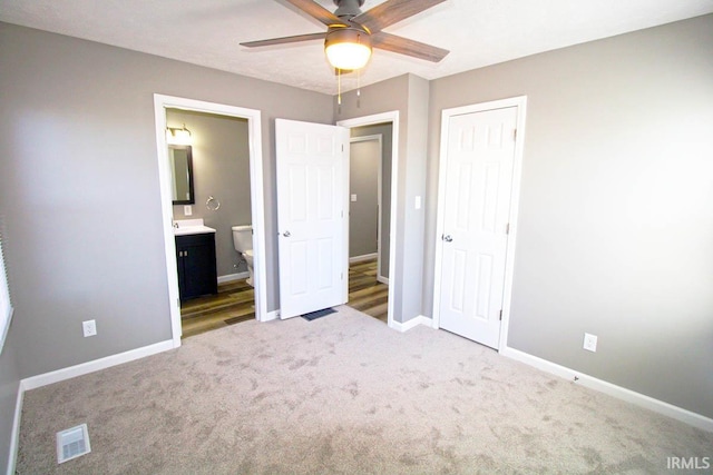 unfurnished bedroom with baseboards, visible vents, connected bathroom, carpet flooring, and a closet