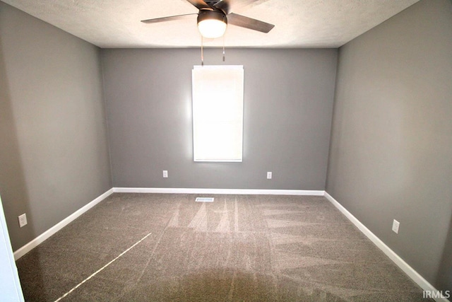 empty room featuring a ceiling fan, carpet flooring, a textured ceiling, and baseboards