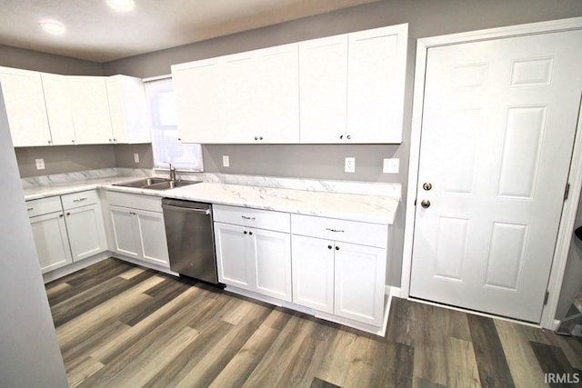 kitchen with dark wood-type flooring, white cabinets, a sink, and stainless steel dishwasher