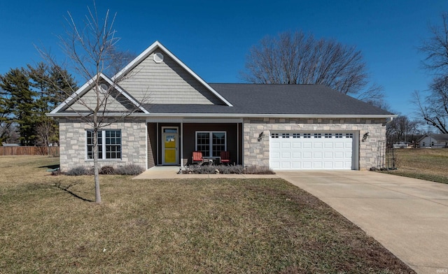 view of front of house with driveway, stone siding, an attached garage, and a front yard