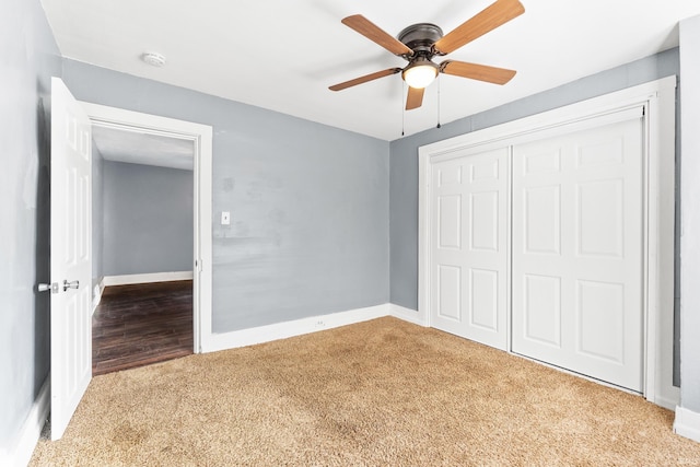 unfurnished bedroom featuring a closet, light colored carpet, ceiling fan, and baseboards