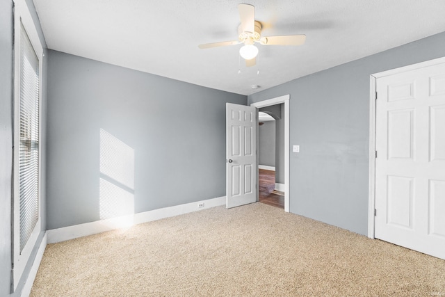 unfurnished bedroom featuring carpet floors and a ceiling fan