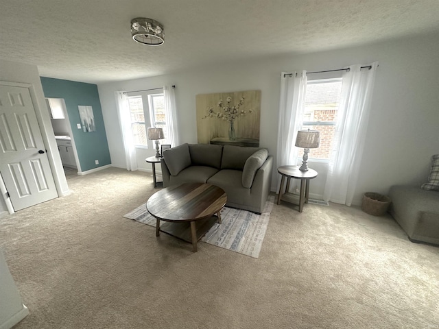 living room featuring light carpet and a textured ceiling