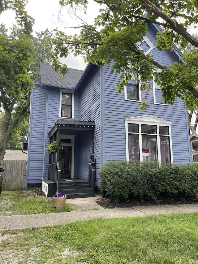 view of front of house featuring fence