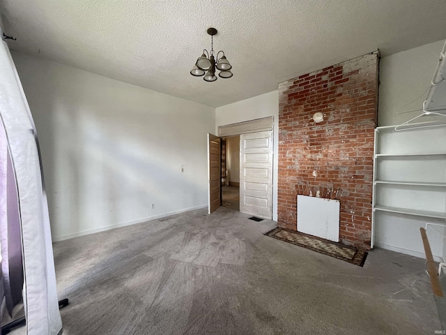 interior space with a textured ceiling, a fireplace, baseboards, and an inviting chandelier