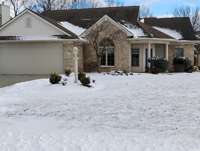 view of front of house featuring a garage and brick siding