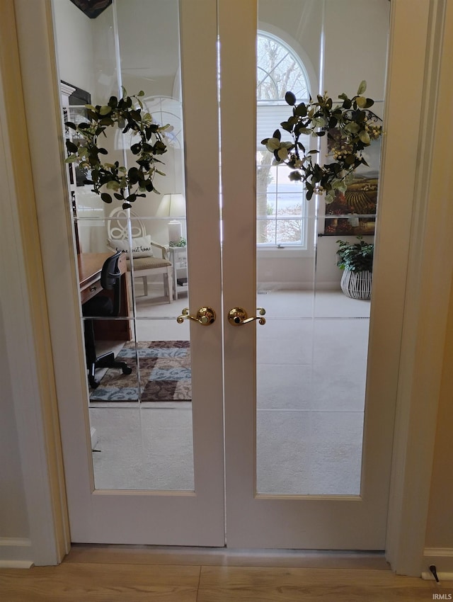 doorway featuring french doors and light wood-style floors