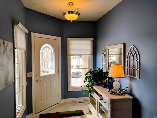 entryway with visible vents, baseboards, and light tile patterned floors