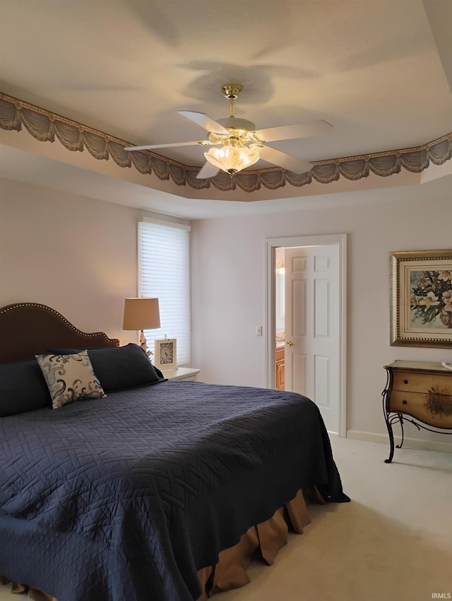 carpeted bedroom featuring a ceiling fan and baseboards