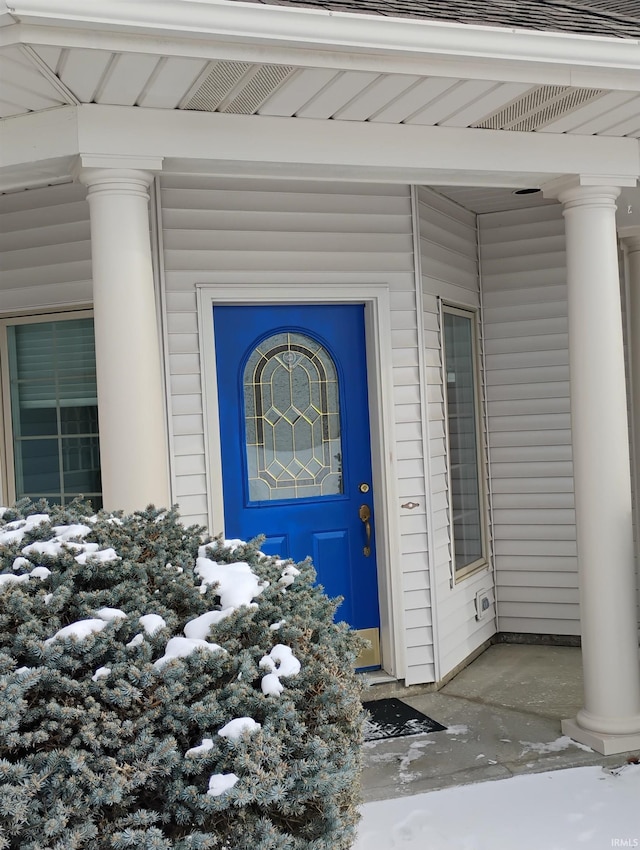 view of snow covered property entrance