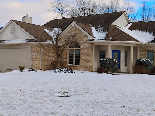 view of front of home with an attached garage and brick siding